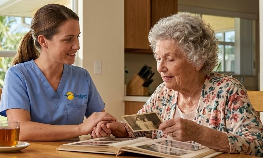 A home companion looking at a photo album with her patient in St. Petersburg, FL